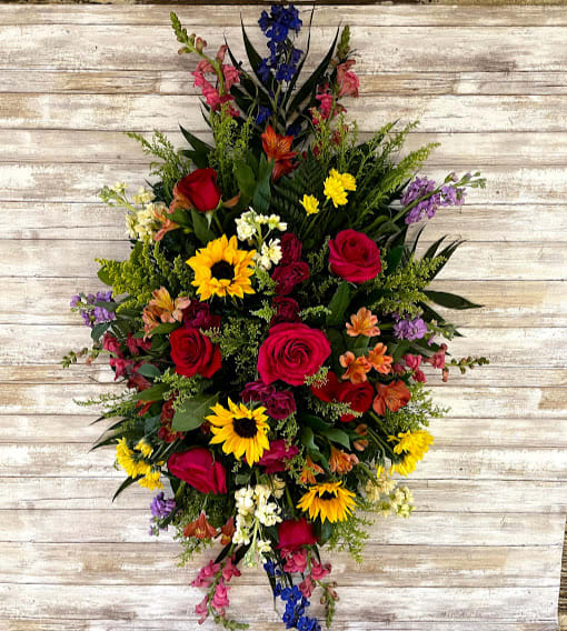 Celebration Of Life Standing Spray Celebration Of Life Standing Spray - A bold, bright tribute, this rainbow of blooms fills the room with a spirit of hope and joy. What a glorious celebration of a love that will live on forever.