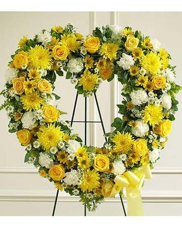 Yellow and White Open Heart - Convey your deepest condolences and undying love with this beautiful arrangement. • Yellow and white flowers such as roses, cremones, carnations and more • Open heart  • Sent directly to the funeral home by family and friends • we use only the freshest flowers available so colors and varieties may vary 