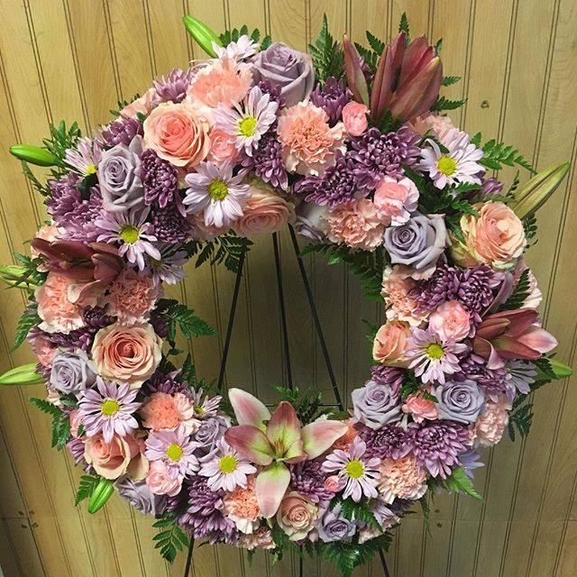 Precious Pastels - Beautiful wreath with pastel purples and pinks including pink roses, lavender roses, lavender pomps, lilys along with greenery. 
