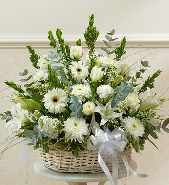 White Sympathy Arrangement in Basket - Product ID: 91236   Send an expression of your sympathy and compassion with this sophisticated and elegant arrangement. White roses, hybrid lilies, Gerbera daisies and more, designed by our select florists in an elegant white washed basket accented with tulle Friends, family and business associates can send this directly to the funeral home or to the family's home Our florists use only the freshest flowers available, so colors and varieties may vary Arrangement measures approximately 28âH x 24âL
