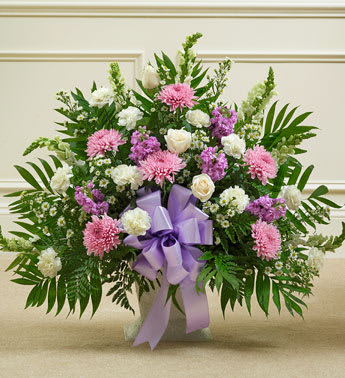 Tribute Lavender &amp; White Floor Basket Arrangement - Product ID: 91210   Expressing all the love you feel in your heart during times of loss is not always easy. This delicate floor basket arrangement helps you convey your care and concern with beautiful lavender flowers to represent a vibrant life, and fresh, white blooms to symbolize purity and peace. Floor basket arrangement of fresh white roses, snapdragons, carnations, lavender mums, lavender stock and more Appropriate for family, friends or business associates to send directly to the funeral home Our florists use only the freshest flowers available, so colors and varieties may vary Large arrangement measures approximately 38&quot;H x 40&quot;L Medium arrangement measures approximately 32&quot;H x 36&quot;L Small arrangement measures approximately 28&quot;H x 30&quot;L