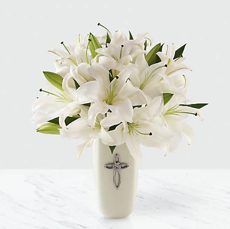 Faithful Blessing Faithful Blessing - The Faithful Blessing Bouquet is an incredible way to celebrate a communion, confirmation, or wedding, as well as send your sympathy for the loss of a loved one. Bringing together stems of fragrant Oriental Lilies, boasting multiple blooms on each stem to create a full and lush flower bouquet, this offering of flowers will bring peace and beauty to any of life's special moments and occasions. Presented in a keepsake designer white ceramic vase with a stunning cross on the front, this exquisite flower arrangement exudes heartfelt blessings with each eye-catching, star-shaped lily.