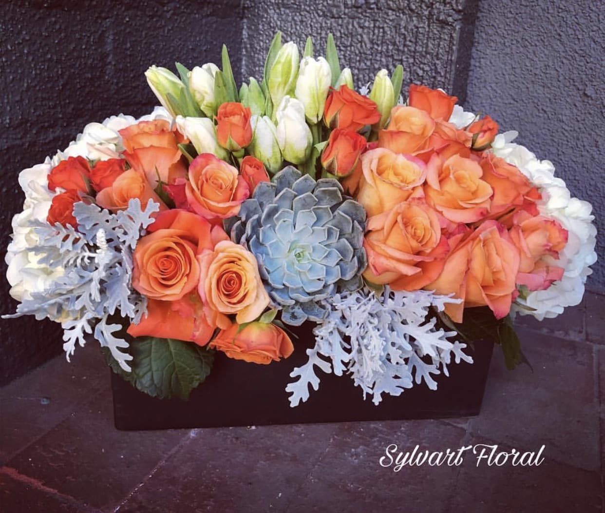 Special someone Special someone - This arrangement dusty miller, succulents, roses, tulips with white hydrangea in a wooden box. (Florals and container might vary due to availability.) Note: If you would like to change floral color, please add your request in the note section when placing your order.