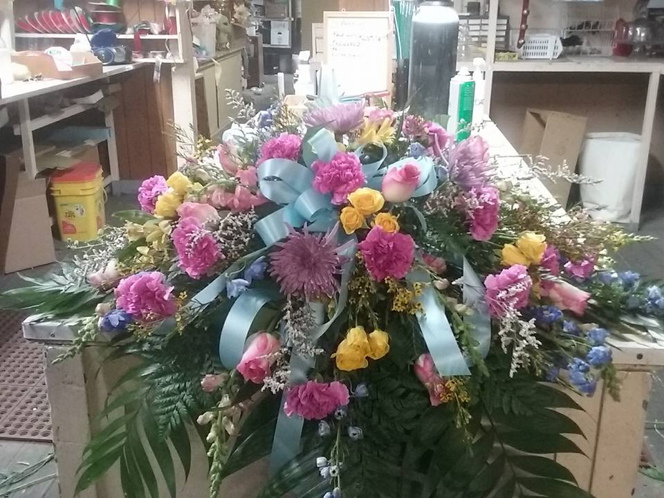 Spring Casket Spray Spring Casket Spray - A bright mix of spring colors fit for every celebration of life