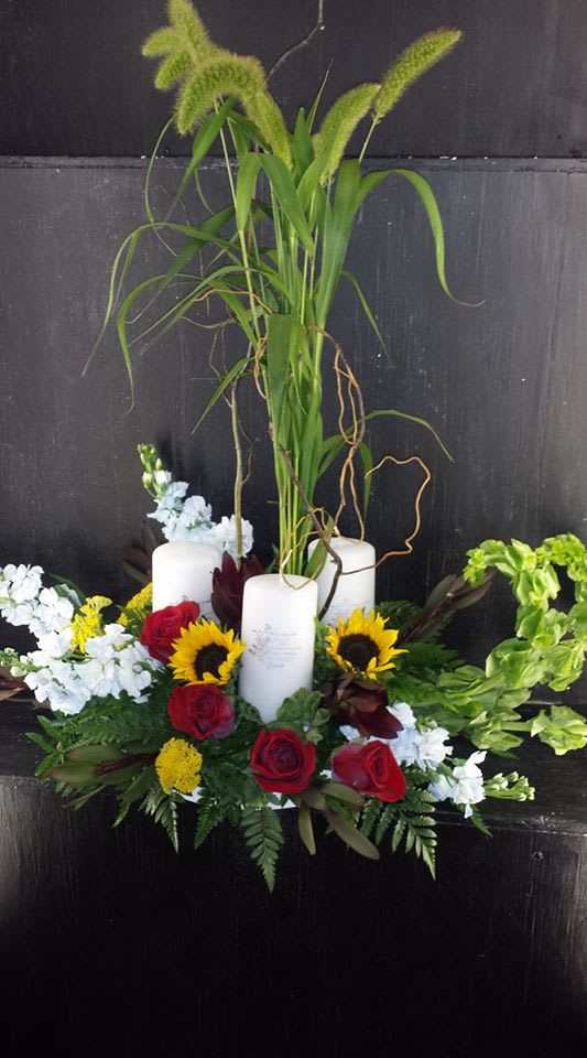 Light the Way Light the Way - Seasonal flowers highlight the trio of candles for a special gift