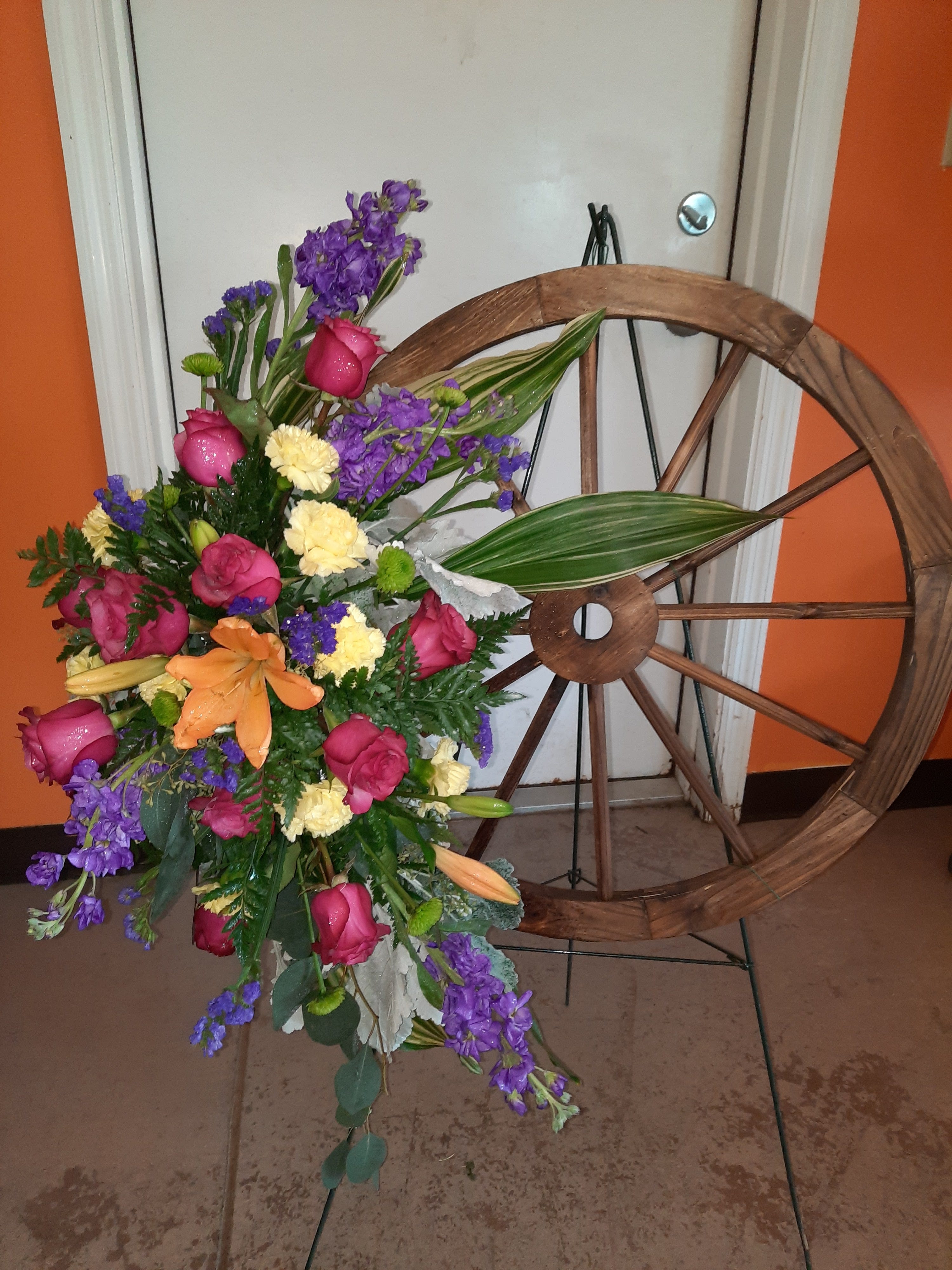 Rolling Through Spring Rolling Through Spring - Mixed flowers on a wagon wheel