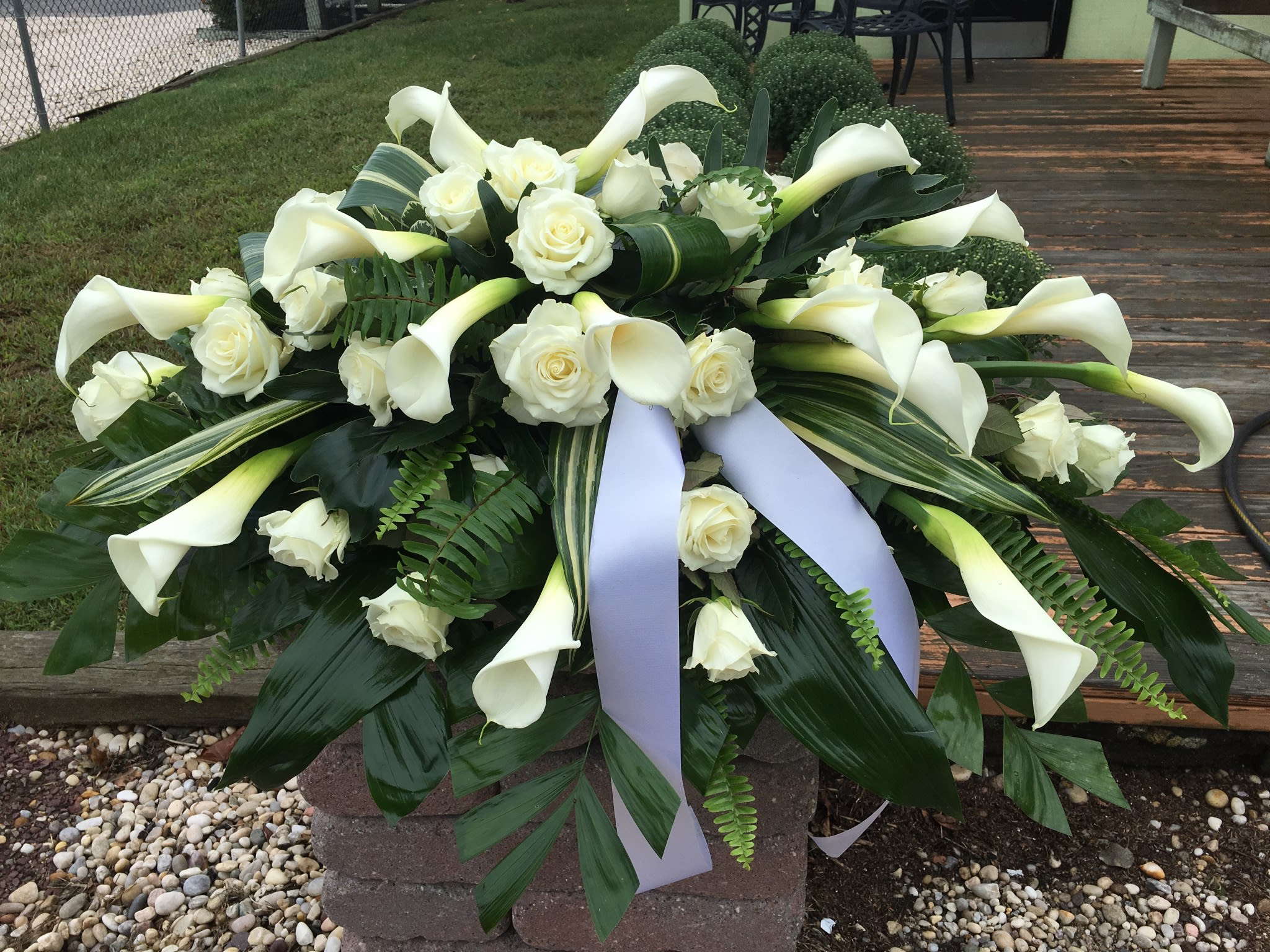 Calla lilies and white roses casket spray by Tall Tree Floral Designs