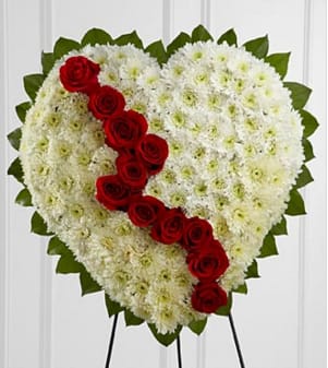 The FTD® Broken Heart™ The FTD® Broken Heart™ - The FTD® Broken Heart™ is a beautiful way to express the impact that the departed had on your life. Pearly white chrysanthemums form the shape of a heart, accented with greens lined around the oustide and "broken" in the middle with a line of rich red roses to create an exquisite way to honor the life of the deceased at their memorial service. Displayed on a wire easel. Approximately 22"H x 22"W. Your purchase includes a complimentary personalized gift message.
