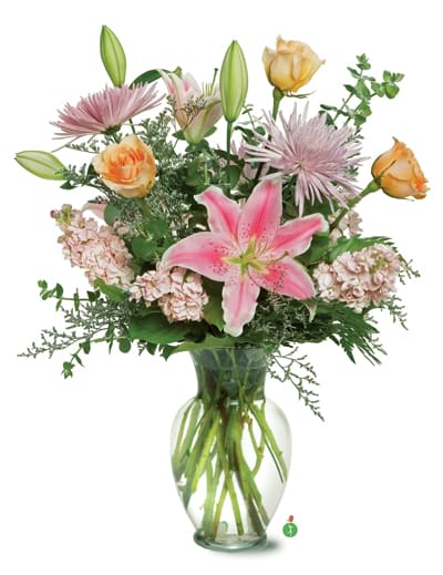 Flirty Floral - Sometimes the simple things in life can bring the most joy – and this flirty mix of pink and peach blossoms, mixed with greenery and presented in a clear glass sweetheart vase – is bright, pretty and perfect for any occasion.