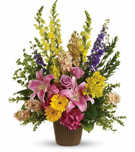 T267-2A Glorious Grace Bouquet T267-2A Glorious Grace Bouquet - Celebrate the spirit of a loved one who is no longer with us with a gorgeous array of roses, lilies and other favorites. The magnificent bouquet includes pink hydrangea, lavender roses, pink oriental lilies, yellow gerberas, yellow alstroemeria, yellow snapdragons, purple larkspur and peach stock, accented with assorted greenery. Delivered in a stylish urn. Approximately 25" W x 31" H
