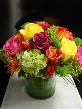 Lush Lush - Lush, exuberant, abundant: hydrangea and roses fill to bursting this leaf-wrapped cylinder vase.