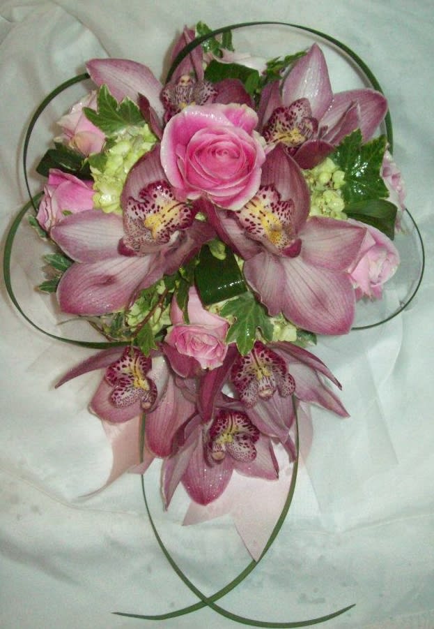Orchid & Rose Tear Drop Bouquet Orchid & Rose Tear Drop Bouquet - Tear Drop Bouquet of Cymbidium Orchids, Roses, Hydrangea, Ivy, Lily grass, and Aspidistra ribbon. This bouquet can be created in colors to better suit any Bride's color palette. This design measures approx. 13"W x 18"L. All bouquets must be ordered a minimum of 72 hours in advance.