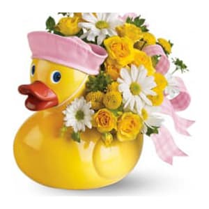 Teleflora's Ducky Delight - Girl - This adorable arrangement takes to baby showers and baby arrivals like a duck takes to water! Available in boy and girl versions this charming arrangement in its cute and reusable keepsake container is well? just ducky! Sunny yellow spray roses yellow button spray chrysanthemums and white daisy spray chrysanthemums are perfectly arranged with a light pink ribbon in an exclusive Just Ducky container. Hand- not stork-delivered! It's delightful.Approximately 10 1/2&quot; W x 11&quot; H Orientation: All-Around As Shown : T04N300ADeluxe : T04N300BPremium : T04N300C