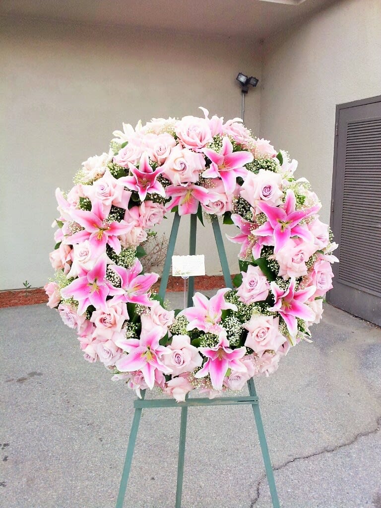 Blush Sympathy Wreath Blush Sympathy Wreath - 27" sympathy wreath filled with blush pink roses and pink lilies. Sympathy arrangements require more prep time, please place your order at least 5 hours prior to start of viewing or service. For optimal quality, we recommend placing your order with a minimum of one day's notice.