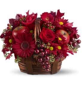 Red Delicious Red Delicious - A deliciously rosy mix of ruby-red blossoms, tucked into a woven basket with faux apples and grapes, creates a festive fall decoration. Celebrate a birthday, or send it to a hostess for the Thanksgiving holiday. A lovely gift for any autumn occasion.