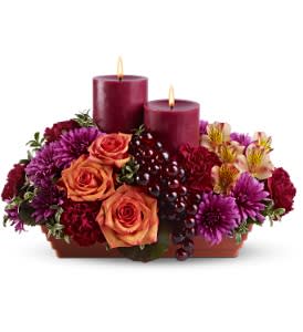 Bordeaux by Candlelight Bordeaux by Candlelight - There's nothing more wonderful than sipping a glass of red wine by candlelight; and this glamorous display is that lovely moment brought to life with flowers! Two pillar candles and glossy grapes complete the picture. An exceptional holiday centerpiece.