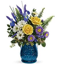 Sapphire Garden Bouquet Sapphire Garden Bouquet - Stunning in sapphire, this glorious glass lantern is the perfect presentation for a beautiful bouquet of yellow roses and blue iris. Later, add a candle for a gorgeous glow!