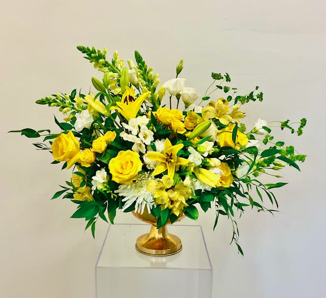 Summer Breeze - Gorgeous display of yellow and white flowers reminiscent of a beautiful summer breeze.  Flowers consist of roses, mums, lily, snapdragon, lisianthus, spray roses, and greenery.