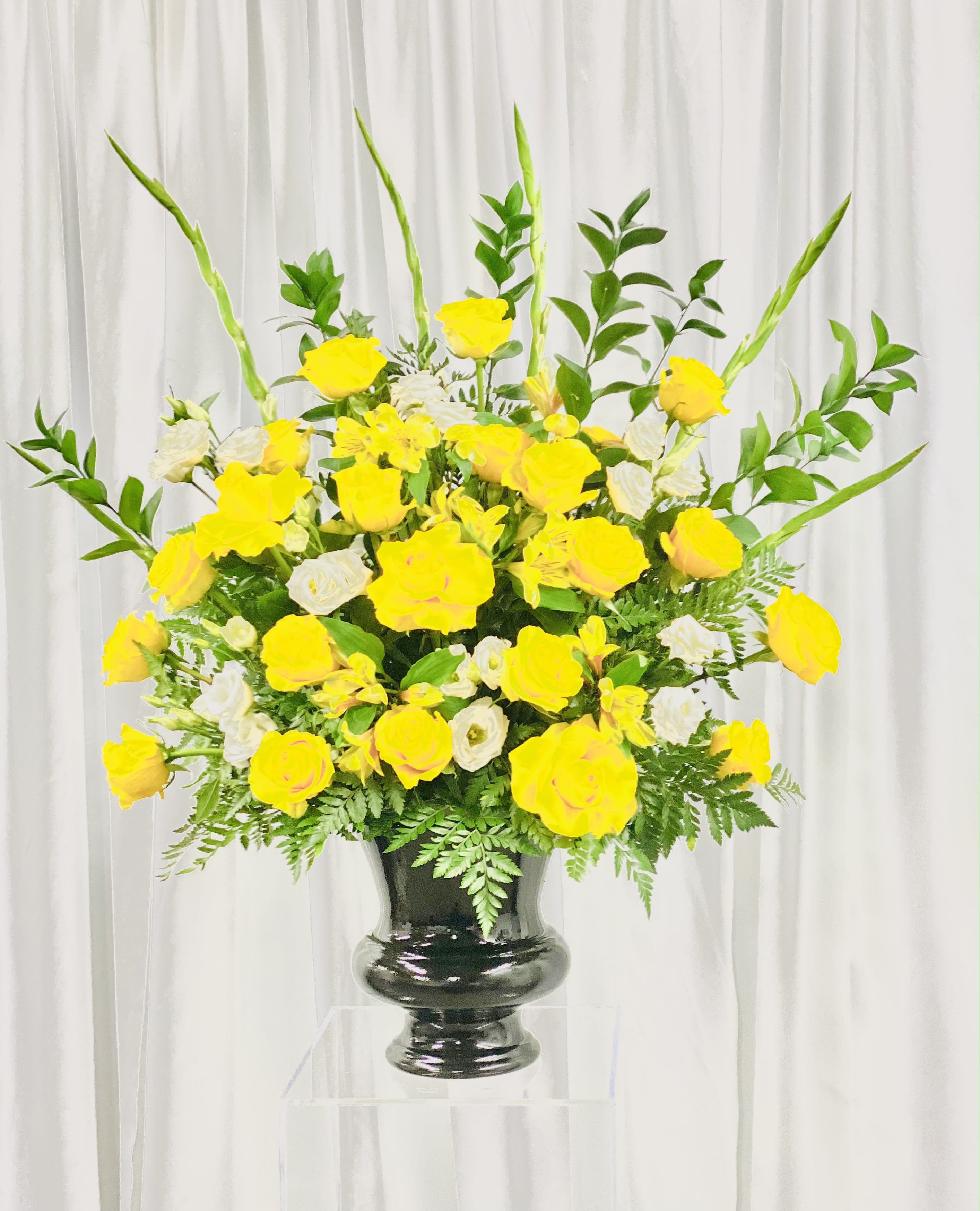 Warm Embrace - A yellow and white display of flowers for that special loved one or friend. Featuring a variety of white, yellow flowers and greenery, this design feels like a warm embrace of comfort. 