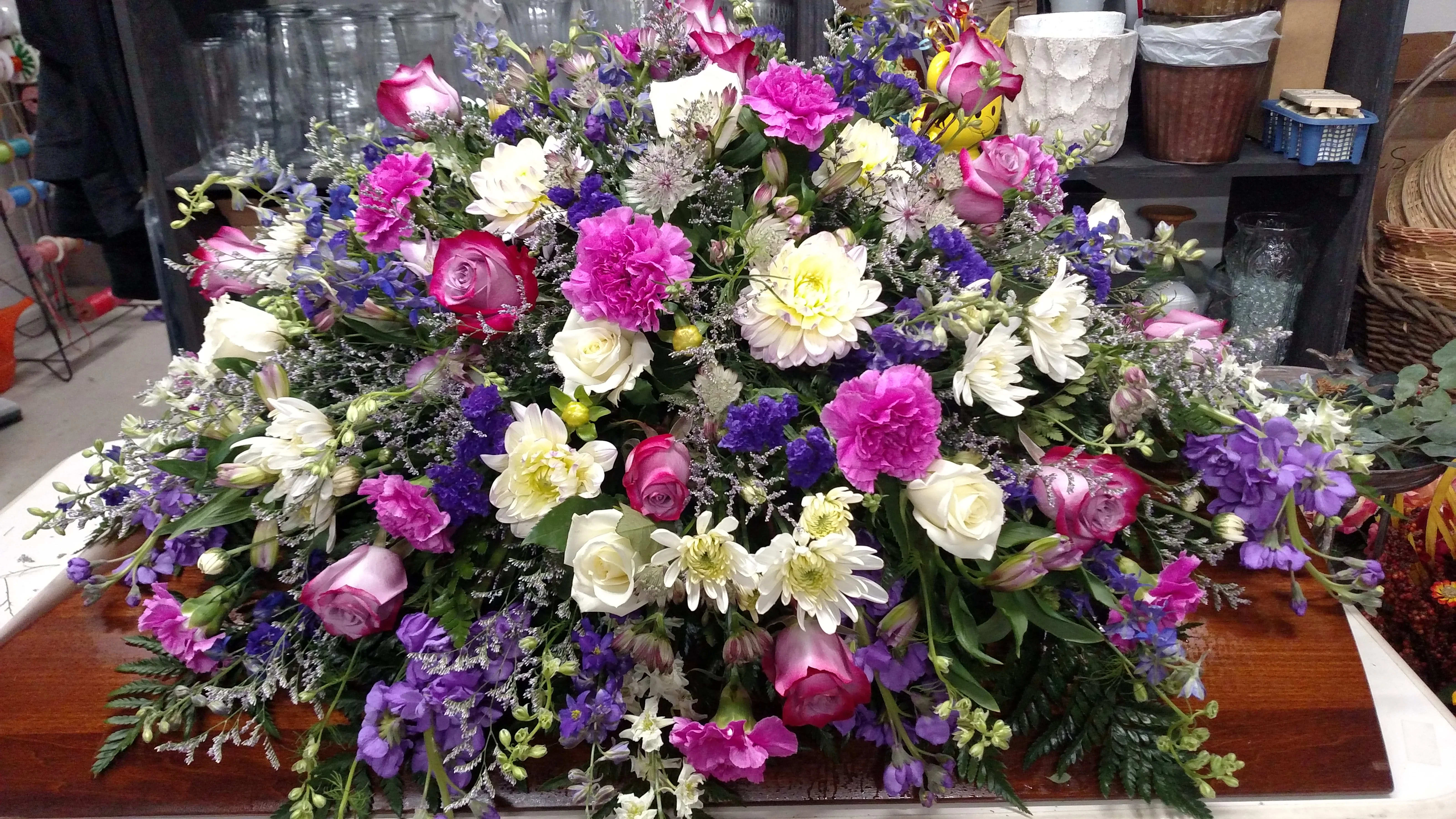 Shades of Purple Casket Spray - Beautiful variety of purple flowers.
