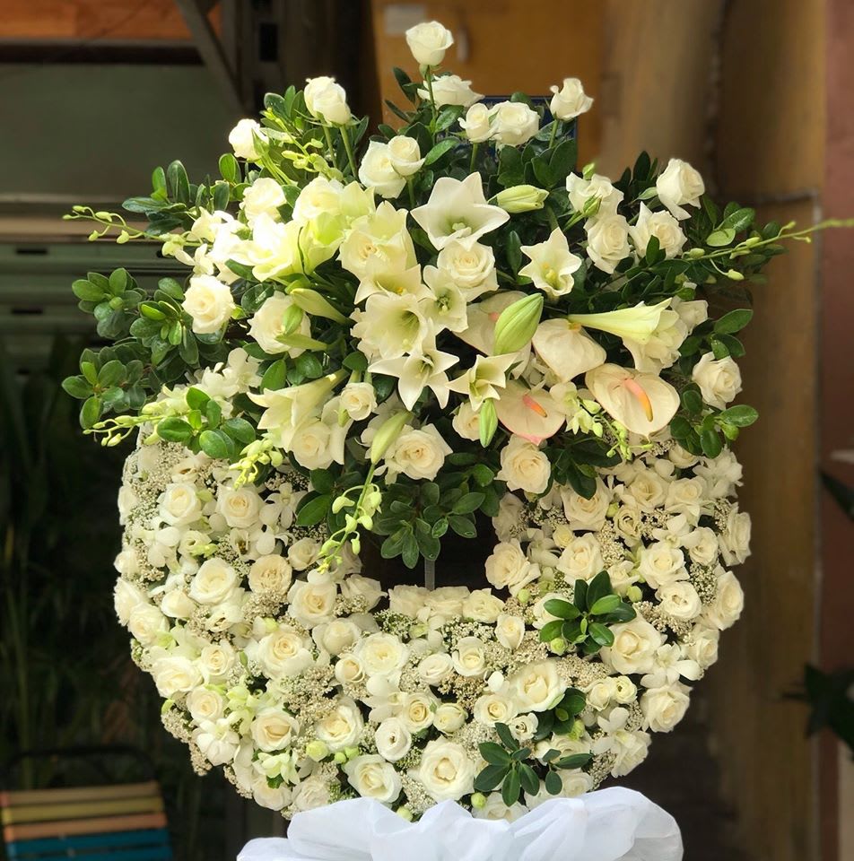 Sympathy Wreath Pure White Sympathy Wreath Pure White - A ring of white Roses and spray roses is delicately accented with a bouquet of white Roses, white orchid, whit anthurium, white lilies and subtle greenery. Remember a loved one with the purity and innocence of white blossoms that adorn this standing wreath arrangement. A profound statement of beauty and grace, to fully show what your heart really says, even with the absence of words.