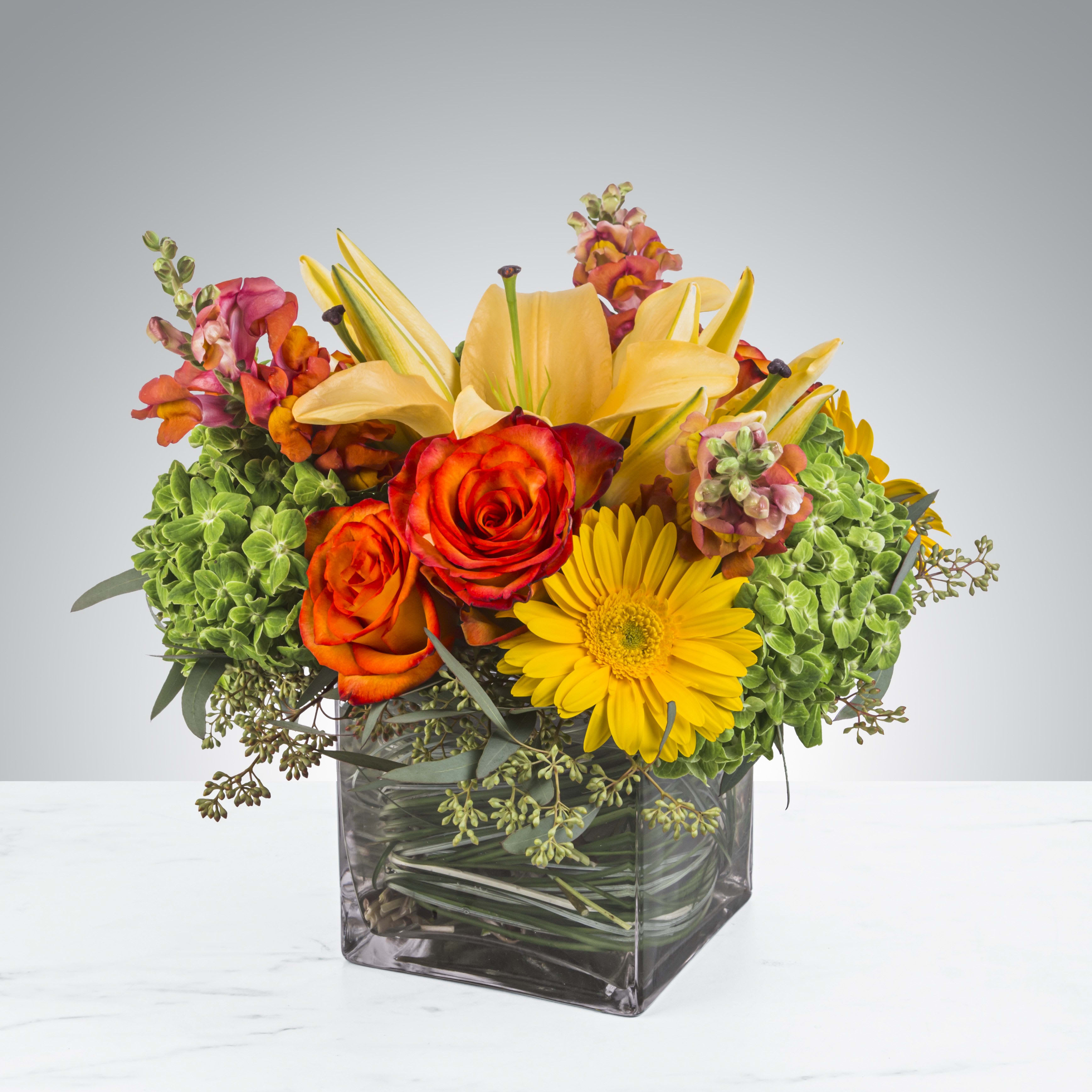 Citrus Splash by BloomNation™ - This bright yellow, green, and orange arrangement includes roses, daisies, and lilies. Citrus Splash by BloomNation™ is the perfect gift for a birthday, thank you or any occasion,    APPROXIMATE DIMENSIONS 14&quot; W X 14&quot; H