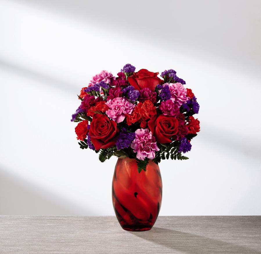 The FTD Sweethearts Bouquet The FTD Sweethearts Bouquet - The perfect expression of love and sweet affection, this Valentine's Day bouquet is ready to send your heart's every wish straight to your recipient's door with blooming beauty. Rich red roses are surrounded by a collection of ruffled blooms including hot pink carnations, red mini carnations, purple statice and fuchsia mini carnations, perfectly accented with lush greens. Presented in a stunning red modern glass keepsake vase, this gorgeous bouquet is ready, set, and styled to celebrate love this coming February 14th. GOOD bouquet includes 10 stems. Approx. 13"H x 11"W. BETTER bouquet includes 14 stems. Approx. 14"H x 11"W. BEST bouquet includes 18 stems. Approx. 15"H x 12"W. EXQUISITE bouquet includes 23 stems. Approx. 16"H x 14"W.
