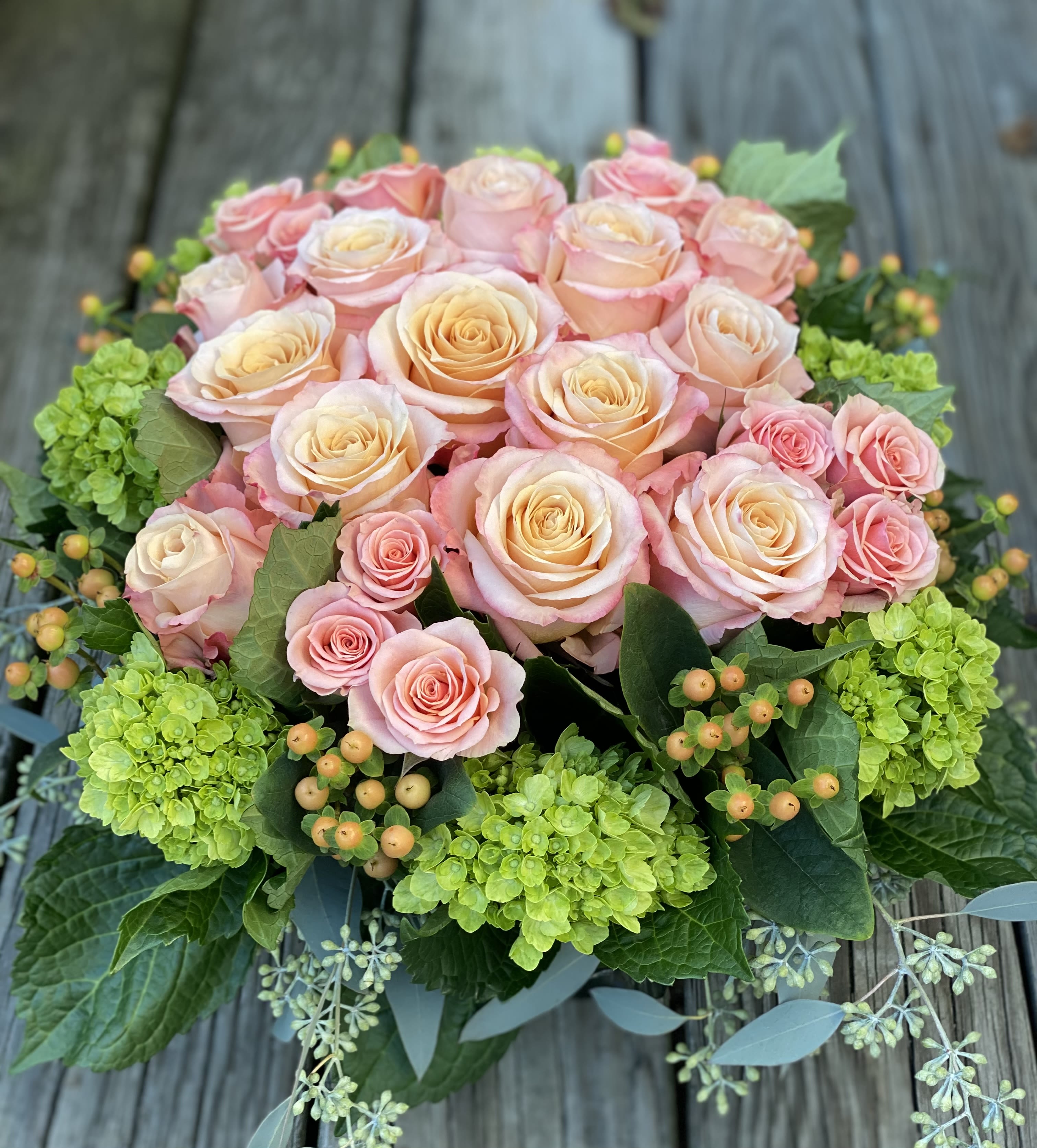 Rose Pave` in Square Vase - Seasonal colored roses in low glass cube, green hydrangeas and berries.