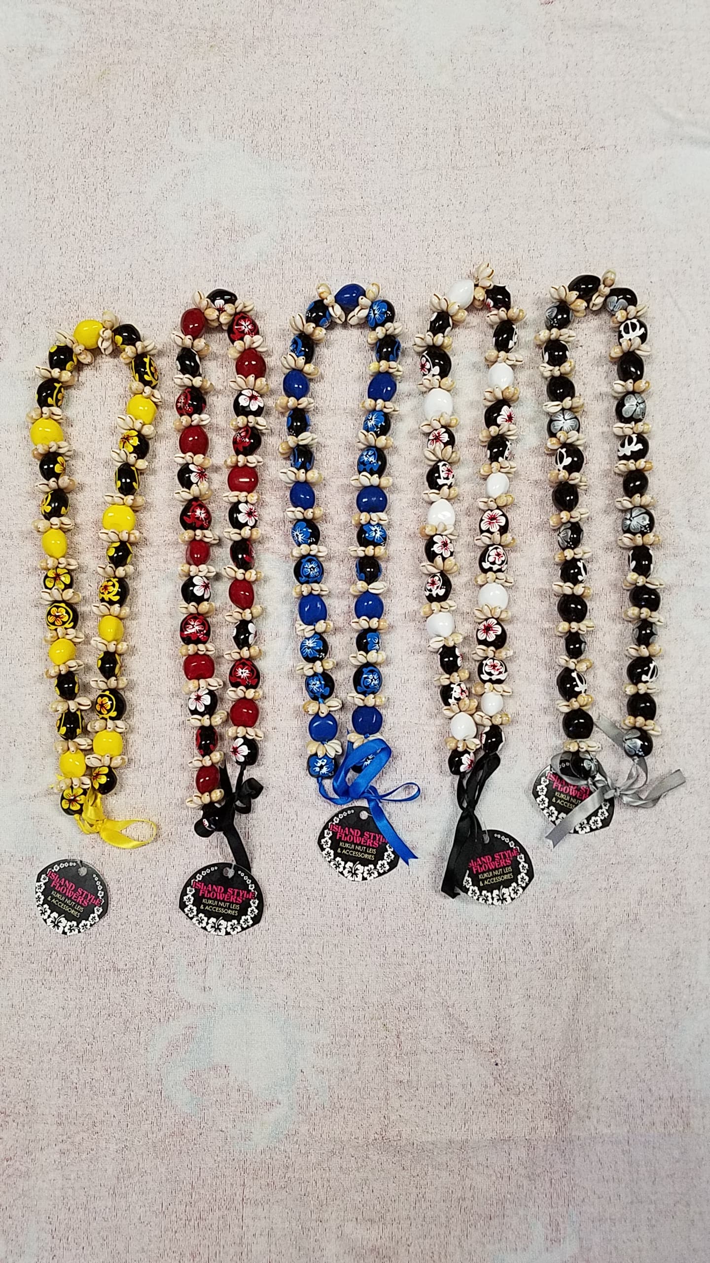 cowrie shell with hibiscus flowers kukui nut lei /necklace - Puka shell ( please specify color when ordering ) Price indicated is for one lei. THERE IS NO RETURN AND REFUND ON THESE LEI. ALL SALES ARE FINAL.