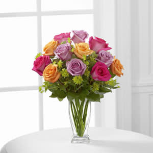 The FTD® Pure Enchantment Rose Bouquet The FTD® Pure Enchantment Rose Bouquet - The FTD® Pure Enchantment™ Rose Bouquet blossoms with brilliant roses in bright hues to capture your special recipient's every attention. Hot pink, lavender and orange roses create a splash of color accented with lush bupleurum to make an exceptional flower bouquet. Presented in a modern clear glass vase, this rose bouquet is set to send your warmest wishes for their birthday, as a thank you gift or to celebrate any of life's special moments.