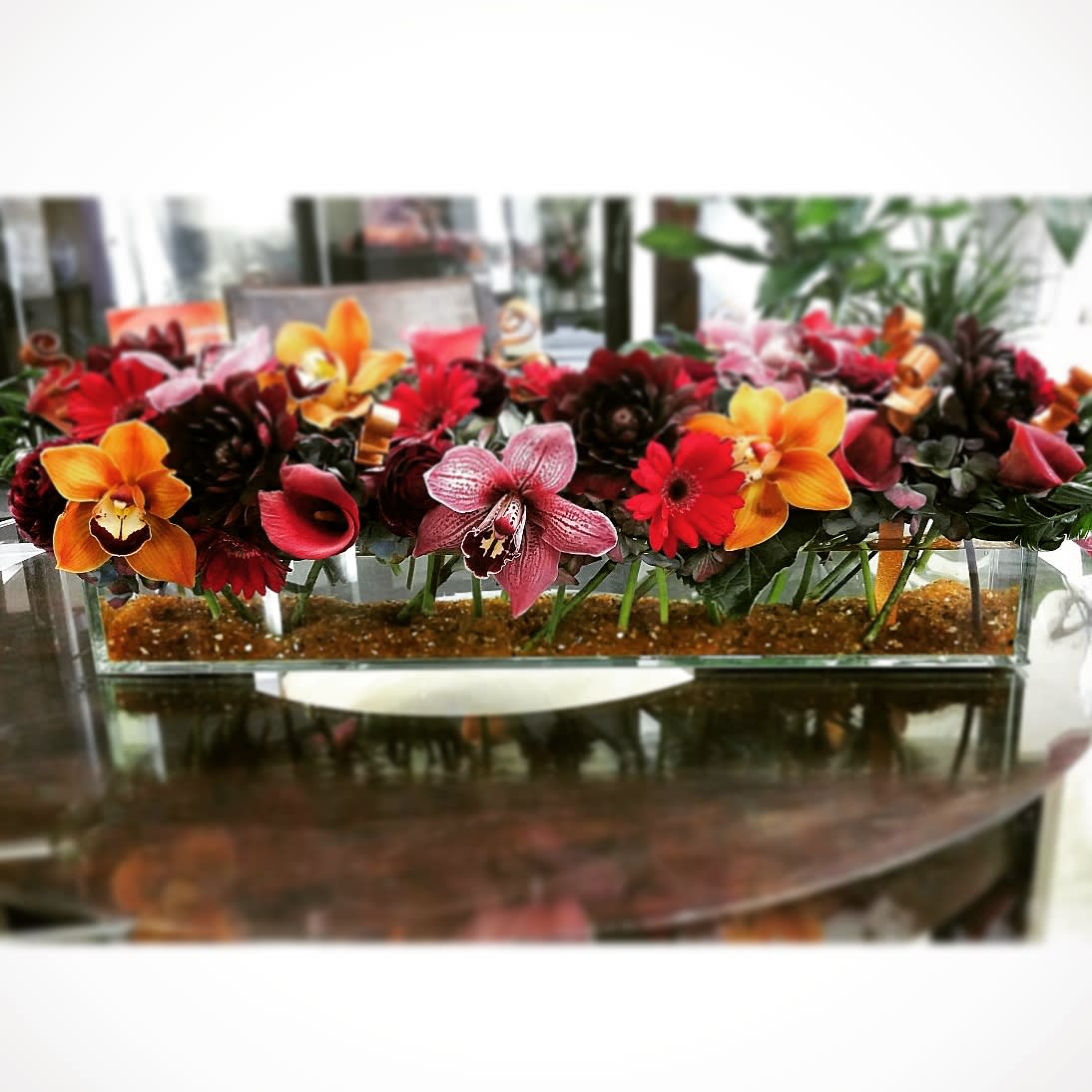 Copper Radiance - A mix of gerberas, hydrangea, callas in rich bold colors adorned with an industrial flare of spiraled cooper, and  gravel to give it a little &quot;natural&quot; mix up.