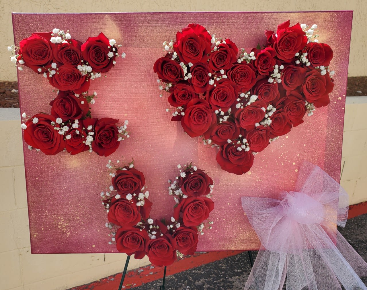 I love you in 3D I love you in 3D - Perfectly painted canvas (you specify the background color and color of roses) with heads of roses spelling out your love. bowed at the corner to seal your love.