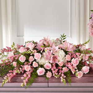 The FTD® Life & Remembrance™ Casket Spray The FTD® Life & Remembrance™ Casket Spray - Pink flowers are comforting, dainty and add a touch of grace to your messages of sympathy. Our Life & Remembrance™ Casket Spray beautifully celebrates the life of a loved one. Each arrangement is handcrafted by a local florist with white hydrangea, pink lilies, roses and carnations. - Details: o Casket spray is approximately 12"H x 51"W
