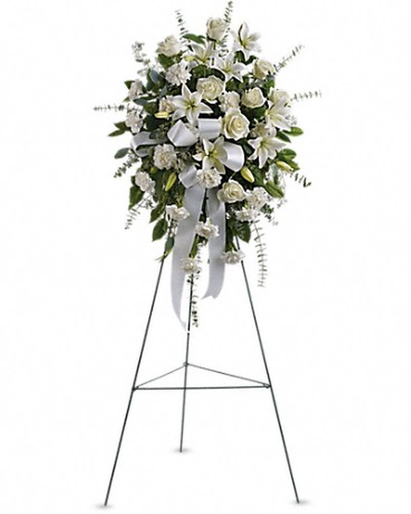 SENTIMENTS OF SERENITY SPRAY - Beautifully simple, this lovely spray of white roses, lilies and carnations decorated with white satin ribbon is a tasteful way to express your sympathy. The elegant spray includes white roses, white Asiatic lilies and white carnations, accented with assorted greenery.