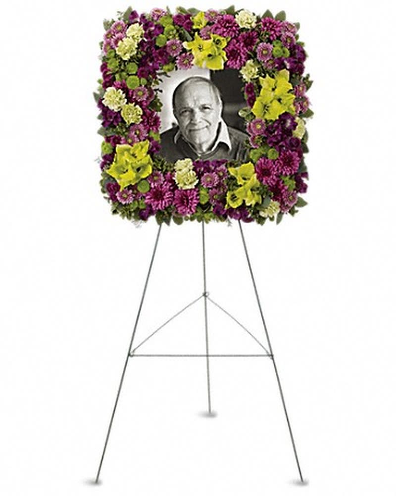 Mosaic of Memories Square Easel Wreath - A unique and lovely tribute for the service, this contemporary square easel wreath of purple and green flowers is a gift of caring expressed with beauty and style. The elegant arrangement includes purple alstroemeria, green gladioli, green carnations, purple cushion spray chrysanthemums, lavender button spray chrysanthemums, green button spray chrysanthemums and purple button spray chrysanthemums, accented with assorted greenery. Orientation: One-Sided All prices in USD ($)