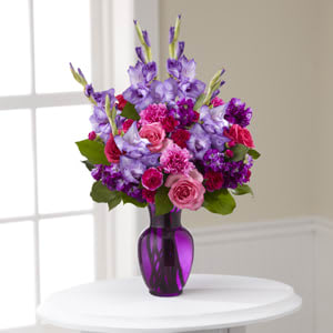 The FTD® Sweet Thought™ Bouquet  - Celebrate a life well-lived with this colorful floral tribute. Handcrafted by a local FTD artisan florist, this arrangement is just right for delivering your message of sympathy at a wake, funeral or to comfort grieving family or friends at home. A vibrant composition of mixed flowers in spring and summer colors combines pink roses and carnations, purple stock and gladiolus arranged in a purple glass vase.