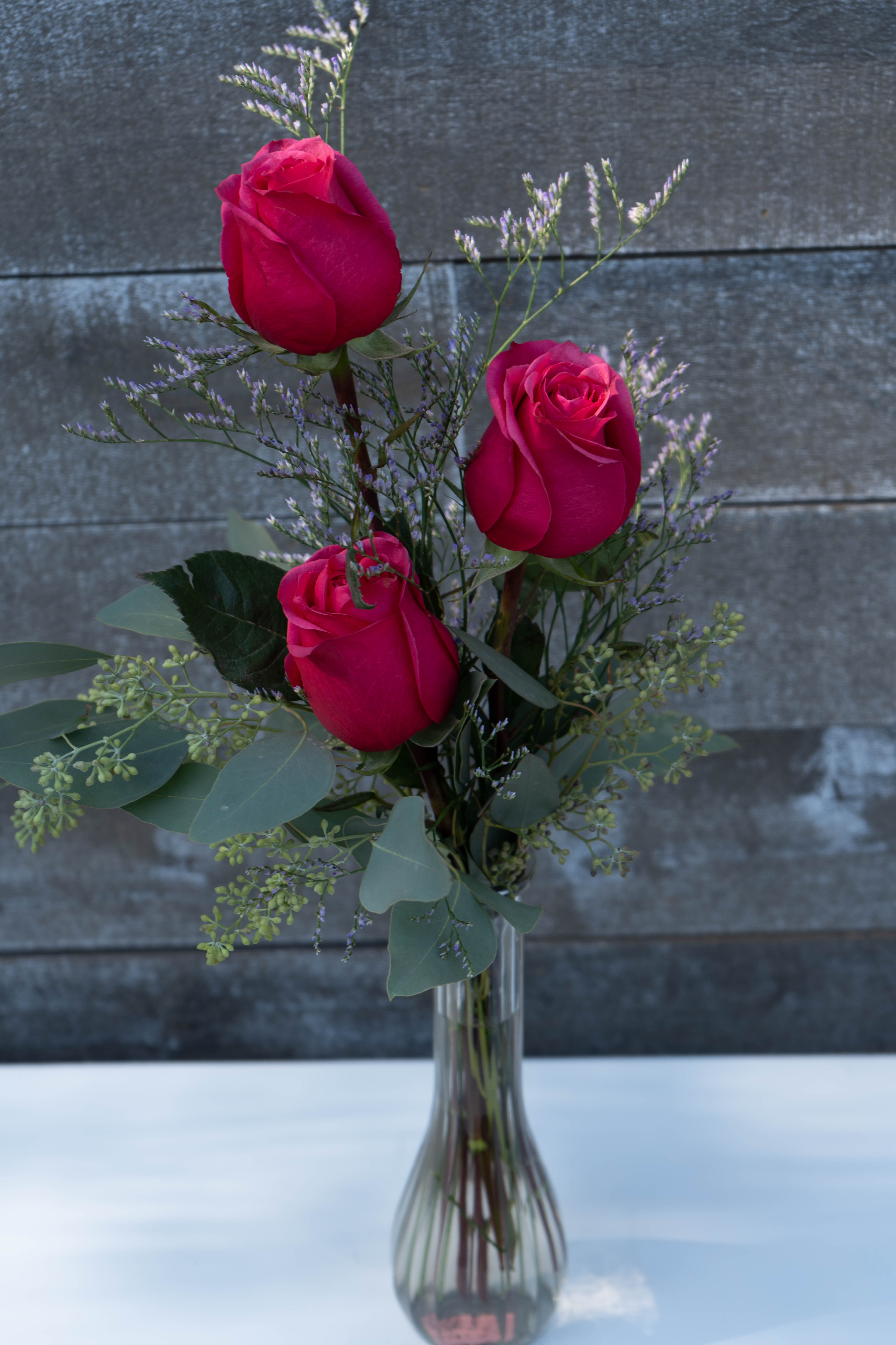 3 hot pink rose bud vase - Classic gorgeous hot pink Ecuadorian roses complimented with Greenery and light filler. Perfect gift for anyone!