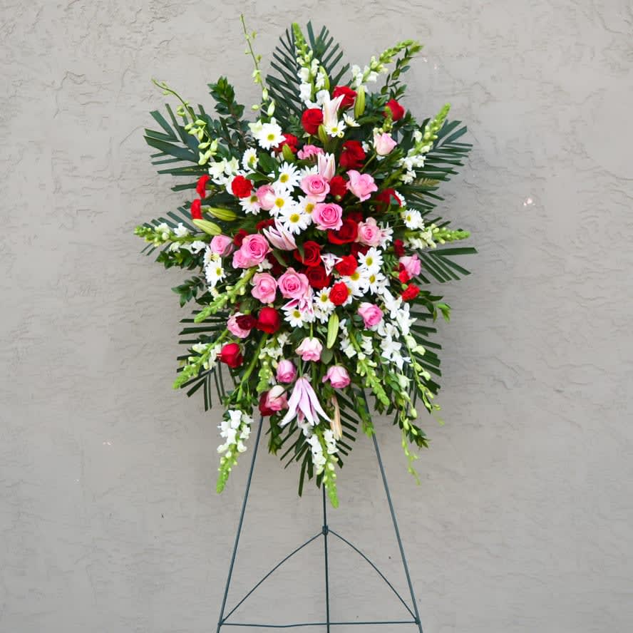 FOND MEMORIES STANDING SPRAY - OUR FOUND MEMORIES STANDING SPRAY comes with snap dragons, dendrobium orchids, roses, pom pom daisy, pink lilies, carnations &amp; palm leaves !! Approximate size: 2 1/2' by 3' 