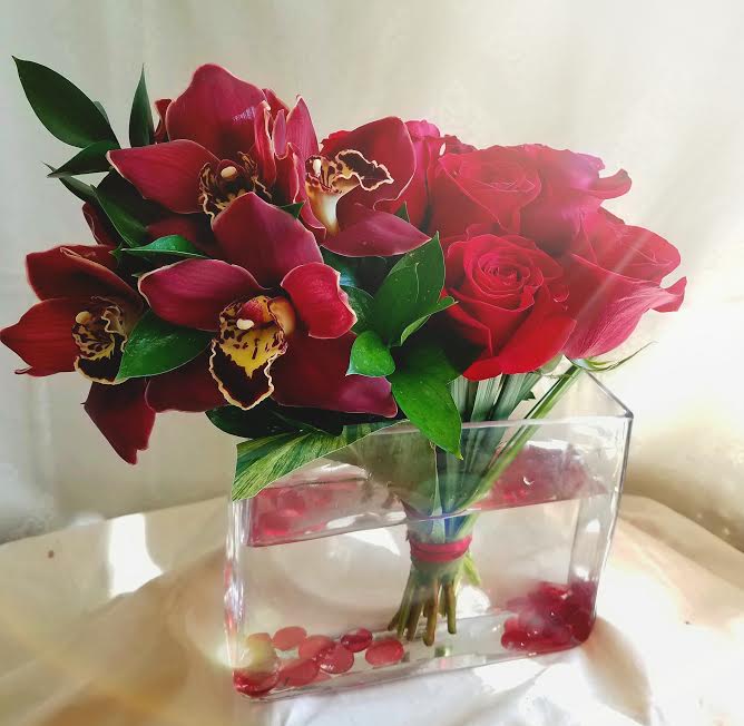  Venice - High style arrangement of roses and cymbidium orchids.