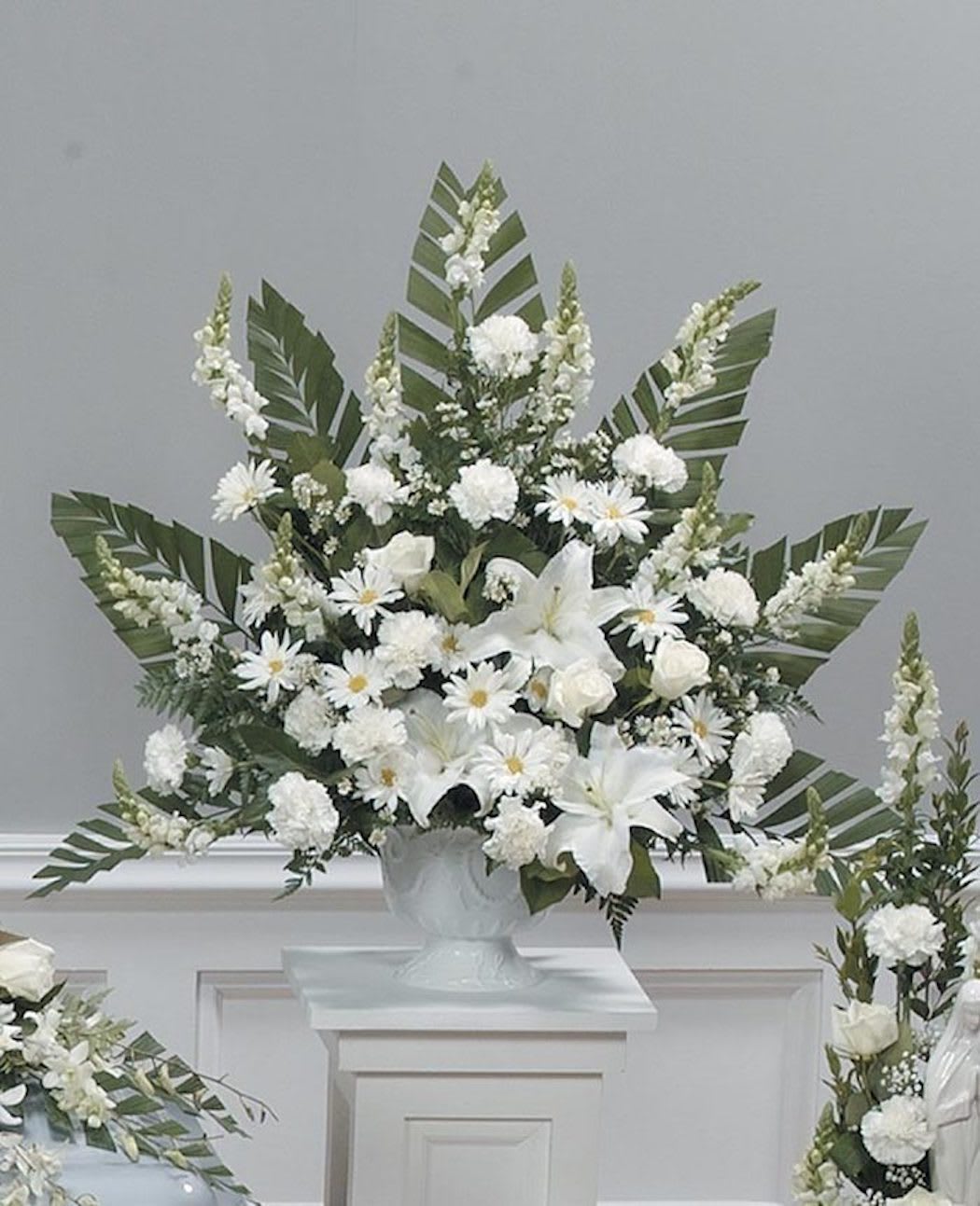Pure Peace - A classic pedestal arrangement of all whites. Includes lilies, roses, daisies and mums. 