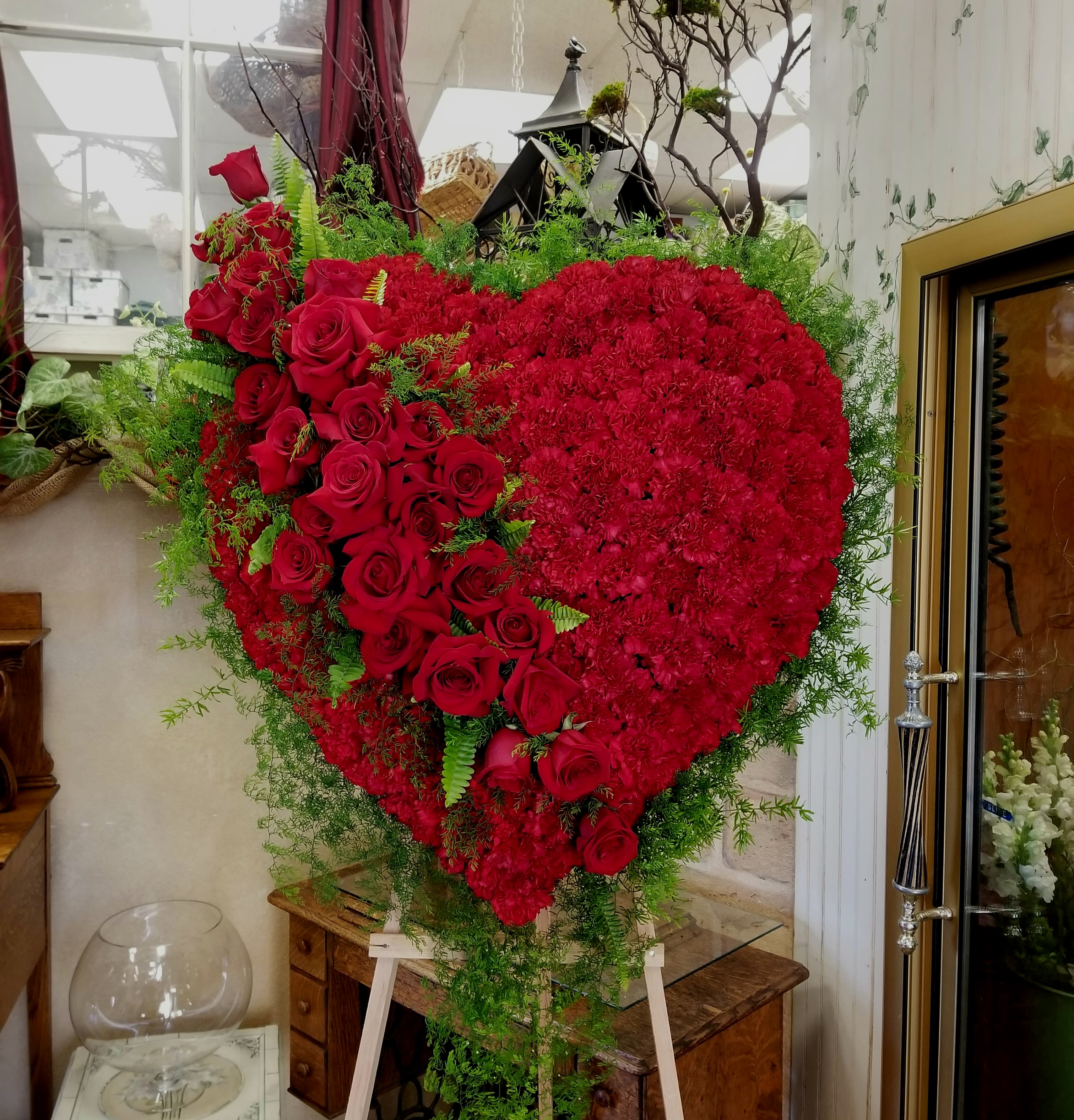 Solid Heart of Love - Red carnations with a diagonal line of red roses.