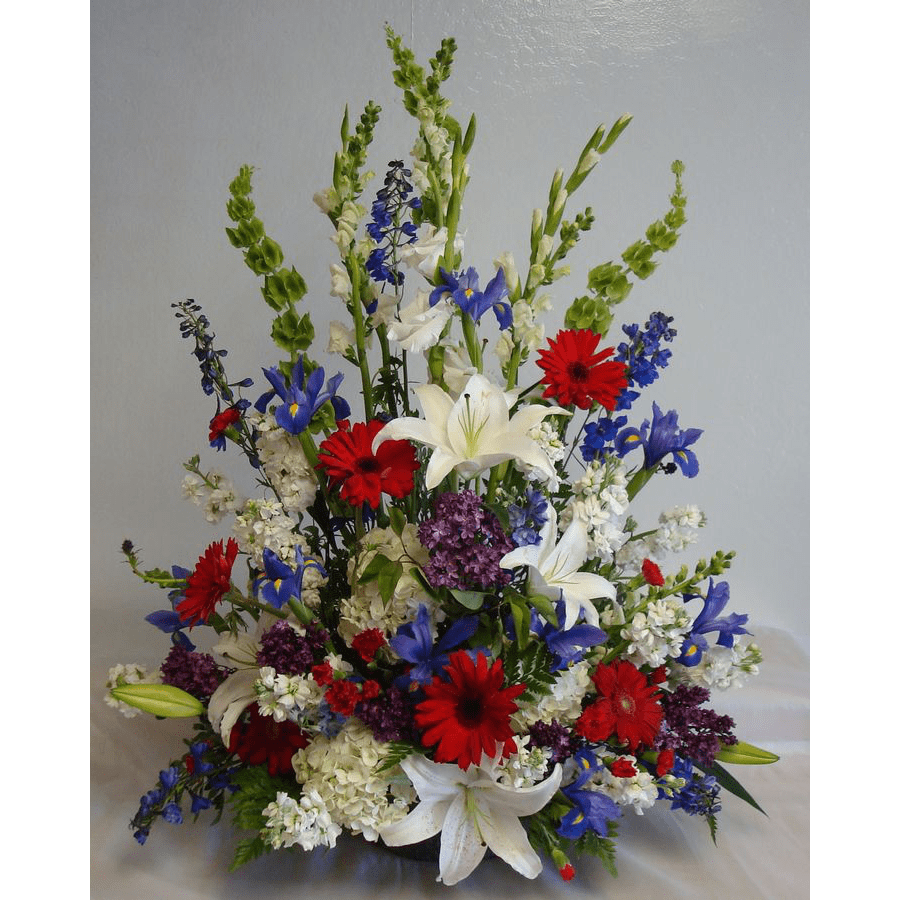 SOME RED, SOME WHITE, AND SOME BLUE IN REMEMBRANCE OF A PATRIOT - Hydrangea, Lilies and others beautifully arranged with mixed greenery and arrayed as an 'A' line arrangement. 