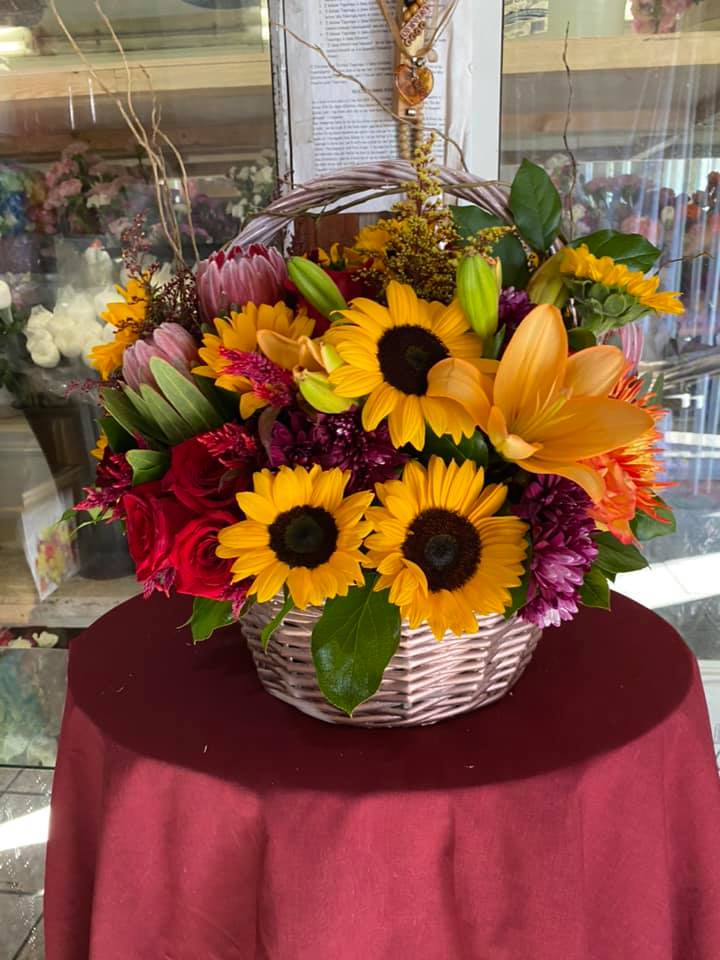 Roses, sunflowers, protea, willow creek, lillies, daisies Roses, sunflowers, protea, willow creek, lillies, daisies - This is a beautiful basket for thanksgiving and it is a round style. It a large size