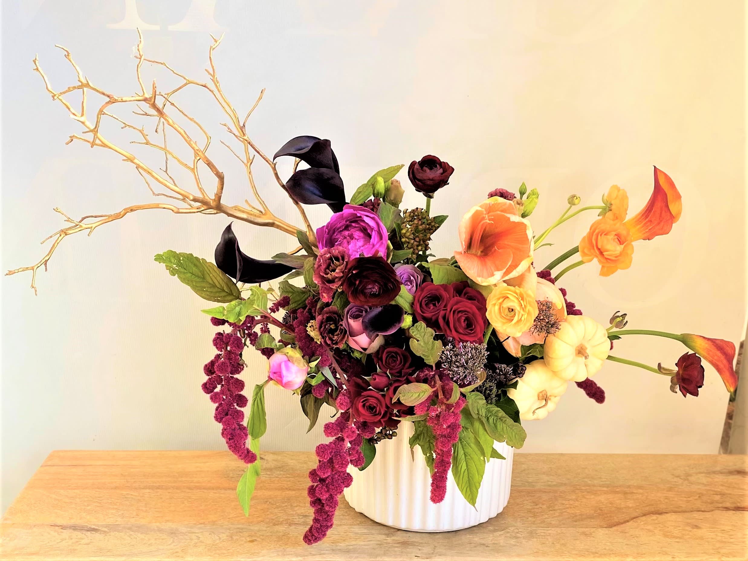 Autumn Party - One of our most popular autumn arrangements! A mix of seasonal autumn flowers in bright tones of burgundy, red, gold, and pink come together to create this beautiful arrangement. Flowers include peony, ranunculus, roses, calla lilies, and mixed greenery.   Centerpiece  make a wonderful treat for yourself or a loved one to brighten up any space with autumn cheer.