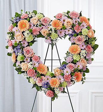 Always Remember™ Floral Heart Tribute- Pastel - The warm and gentle love they showed to those around them will keep them always remembered. This sentiment is best captured with our standing, open heart-shaped arrangement in pastel hues. Handcrafted by our caring florists with an assortment of soft, pastel blooms, it is a magnificent tribute fitting for the funeral services.