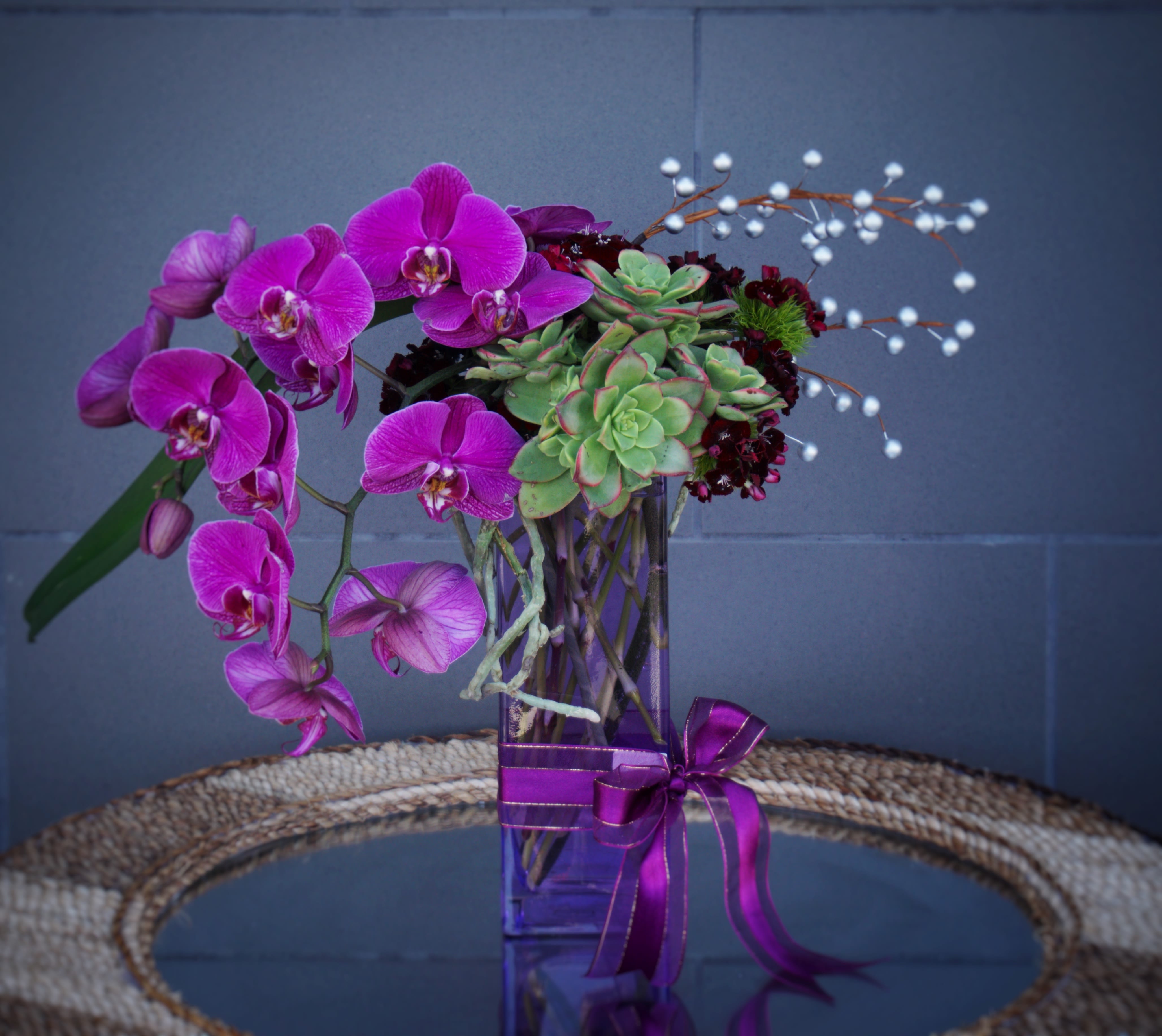 Purple Sunset - A lovely purple design with orchid, sweet william, succulents, pearls and accents in a nice vase. 