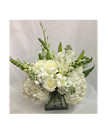 Graceful Blooms Bouquet Graceful Blooms Bouquet - In this all white hand arranged bouquet you see Hydrangea, Roses, Lilies, Orchids, Snaps Dragons in a clear cube vase. Flowers are subject to change due to availability. FCF-0219