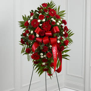 The FTD® Treasured Memories™ Standing Spray The FTD® Treasured Memories™ Standing Spray - The FTD® Treasured Memories™ Standing Spray is a rich and colorful way to express your unending love and devotion to the departed. An exceptional arrangement of red roses, burgundy carnations, burgundy mini carnations, red gerbera daisies and white button poms are accented with a variety of lush greens. A red ribbon with the word, "Beloved," embossed in a gold metallic lettering, finishes this beautiful display for their final farewell service. Displayed on a wire easel.
