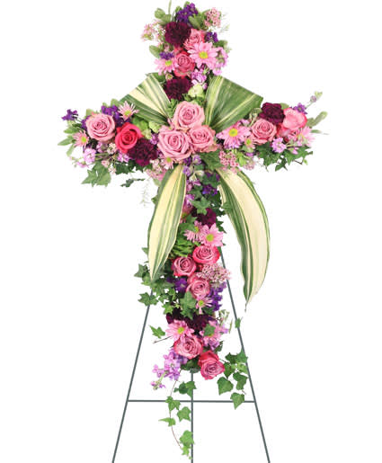 ROYAL FAREWELL STANDING SPRAY - Praise your loved one with a floral cross that truly represents their devotion to their friends, family, and community. The Royal Farewell standing spray brings radiant beauty and cherished comfort to those who are mourning. Featuring vibrant bi-colored roses in stunning hues of lavender, pink, and maroon with an aspidistra accent and a luscious sea of ivy, this floral cross is a peaceful and reassuring addition to any funeral service, memorial service, or wake. 