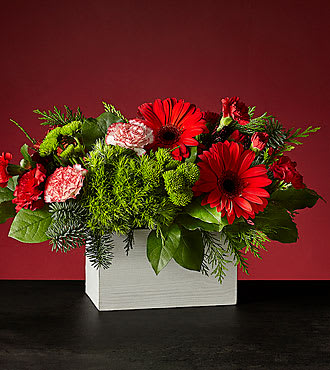 HOLLY JOLLY BOUQUET - WOODEN BOX FILLED WITH EVERGREENS,  RED GERBERA, PEPPERMINT CARNATIONS, RED  AND MINI CARNATIONS 